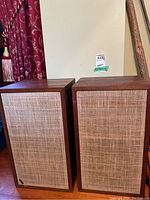 Pair of Dynaco speakers with wood veneer cabinets and cloth grilles