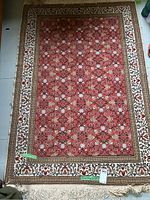 Top-down view of the entire Persian rug showing the floral pattern and borders.
