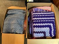 Two boxes filled with handmade afghan quilts, some crocheted and some knitted, showing different colors and textures.