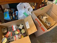 Box with multiple small containers holding assorted screws, nails, and staples,