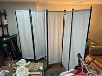 6-panel room divider shown unfolded in a basement space with surrounding items.