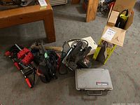 Overview of lot including clamps, sledge hammer, cords, craftsman rotary tool case, and circular saw