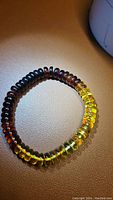 Top view of the AAA Baltic Amber Bracelet showing the full color gradient from dark to yellow beads.