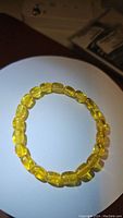 Photo showing golden chunky translucent amber beads strung on a stretchy bracelet.