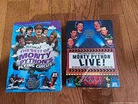 Front view of two Monty Python DVDs showing colorful box art and titles.
