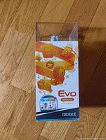 Front view of Ozobot Evo Starter Kit box with clear plastic top showing the spherical robot inside.