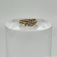 Front view of the 14k gold ring showing the diamond cluster and band design.