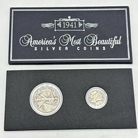 Original box titled '1941 America's Most Beautiful Silver Coins' with two silver coins in protective cases mounted on black cardboard.