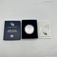 2016 American Eagle silver coin displayed in original United States Mint box with certificate of authenticity.