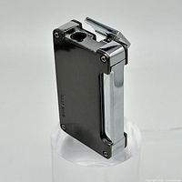 Full view of the Bugatti lighter showing black and silver metal with flip-top and ignition hole.