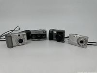 Four cameras displayed in a row showing size and design variations.