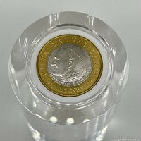 Closeup front image of one Vatican Lire 1000 coin showing Pope John Paul II profile and inscriptions.