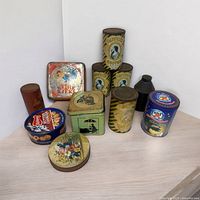 Photo of all 11 vintage tins including several Caswell's Coffee tins and assorted decorative designs