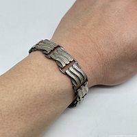 Bracelet worn on wrist showing its fit and design detail.