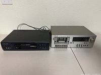 Photo of TEAC cassette tape deck and Mitsubishi VHS player side by side