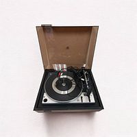 Front view of the United Audio Dual 1225 turntable with dust cover open showing platter, tonearm, and controls