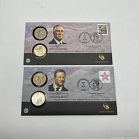 Front view of two US Mint coin sets for Franklin D. Roosevelt 2014 and Theodore Roosevelt 2013, each with stamp and official postal cancellation marks on presentation folder.