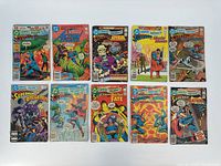Top view of all 10 Superman DC Comics laid out on a white surface showing front covers