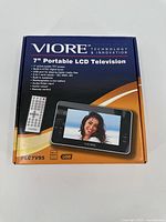 Closed box of Viore 7" Portable LCD Television showing product image, remote control, and key features.
