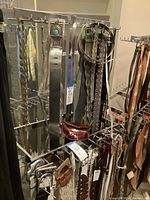 Front view of both chrome belt racks with belts for staging only