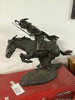 Full side view of statue showing horse, rider and base