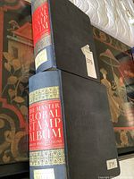 Two Minkus Master Global Stamp Albums stacked to display blue cloth covers and red/gold spine labels