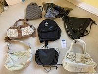 Overview of nine assorted purses and bags on beige carpet