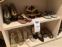 Full view of two-tier shelving displaying eight pairs of women’s shoes