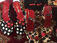 Four pairs of ladies used shoes around size 7.5 including animal print, heart print, and bead embellished styles.