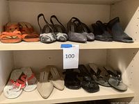 Shelf with six pairs of used ladies shoes, size 7.5 including orange slingbacks, patterned slingbacks, silver snakeskin heels, black heeled mules, tan mules, and three pairs of flat sandals.