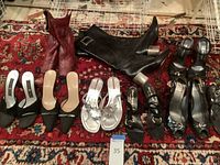 Overview of all boots, heels, sandals arranged on red patterned rug