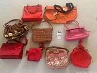 Top-down view of all eight colorful designer purses arranged on carpeted floor