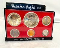 Front view of the 1976 US Proof Set plastic encased coins on red backing showing all six coins.
