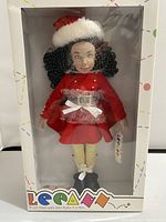 Front view of the Leeann doll dressed as Santa's Helper inside display box showing outfit and face details.