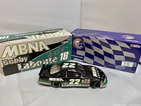 Original packaging boxes with the diecast model car displayed outside, showing MBNA branding and Bobby Labonte signature on the box.