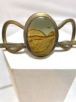 Close-up image of vintage brass hair decor showing the central jasper picture stone with landscape-like pattern.