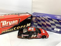 Model car placed outside original box showcasing car's design and packaging condition.