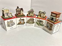 Six model buildings each displayed on their corresponding Americana Collection boxes, showing detailed front facades and paint colors.