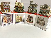 Five miniature Liberty Falls village buildings, each on its original box, showing front and side views.