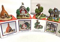 Photo of four miniature Liberty Falls Village buildings with original boxes: Pottery Kiln, Pottery Shop, Old Windmill, Pottery Residence