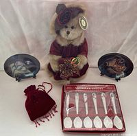 Full view of lot items including Bearington bear, display plates, snowman spoons in packaging, and velvet sachet.