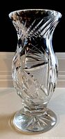 Crystal vase with detailed cut patterns and swirl top photographed in natural light from the front