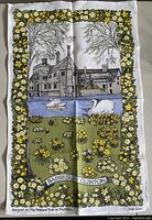 Tea towel depicting Baddesley Clinton Tudor manor house with swans on moat, surrounded by yellow flowers border, Irish linen, never used.
