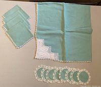 Green tablecloth, 4 matching dinner napkins, and 8 coasters with crocheted edges
