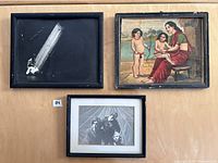 Three framed artworks laid on a table: Indian painting, theatrical photo, and damaged photo.
