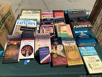 Photo showing the full collection of vintage books laid out on ground, showing various titles and cover artwork for detailed inspection.
