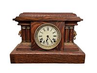 Front view of 1911 Arthur Pequegnat mantle clock with visible clock face, Roman numerals, and tiger oak wood case.