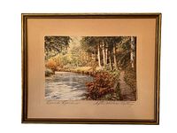 Framed print artwork showing a nature scene of trees and a waterway, signed 'Beech Borders' and 'After Wallace Nutting'. The frame is gold-colored with no glass.