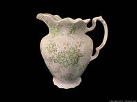 Front and side view of antique Burslem Japonica porcelain water jug with green floral pattern and scalloped rim