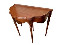 Half-sized walnut folding entrance table with scalloped edges and four turned legs, shown folded down.